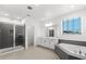 Bright bathroom featuring a walk-in shower and soaking tub for a spa-like experience at 2628 Cedar Shake Ct, Oviedo, FL 32765