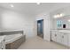 Bright bathroom featuring a soaking tub and white cabinets at 2628 Cedar Shake Ct, Oviedo, FL 32765