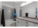 Cozy bathroom with shower over tub, white cabinets, and neutral countertops at 2628 Cedar Shake Ct, Oviedo, FL 32765