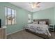 Comfortable bedroom with natural light, ceiling fan, and neutral color scheme at 2628 Cedar Shake Ct, Oviedo, FL 32765