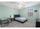 Comfortable bedroom with a ceiling fan and a large window at 2628 Cedar Shake Ct, Oviedo, FL 32765