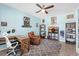 A blue themed bedroom with a wooden desk, comfortable brown chair, and ceiling fan at 2628 Cedar Shake Ct, Oviedo, FL 32765