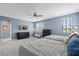 Bright bedroom featuring two beds, an entertainment center, and natural light from the window at 2628 Cedar Shake Ct, Oviedo, FL 32765
