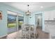 Dining area with sliding glass doors to patio and backyard, modern light fixture, and tile flooring at 2628 Cedar Shake Ct, Oviedo, FL 32765