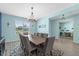Formal dining room with modern chandelier, ample seating, and large windows at 2628 Cedar Shake Ct, Oviedo, FL 32765