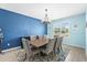 Formal dining room with modern chandelier, ample seating, and large windows at 2628 Cedar Shake Ct, Oviedo, FL 32765