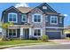 Charming two-story home featuring a stone facade, gray paint, and a two-car garage at 2628 Cedar Shake Ct, Oviedo, FL 32765