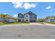 Attractive two-story home boasting stone accents, blue siding, a well-maintained lawn, and a two-car garage at 2628 Cedar Shake Ct, Oviedo, FL 32765