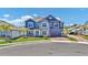 Inviting two-story home with stone accents, blue siding, lush landscaping, and a convenient two-car garage at 2628 Cedar Shake Ct, Oviedo, FL 32765