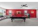 Large game room with a pool table, arcade games, and a comfortable seating area at 2628 Cedar Shake Ct, Oviedo, FL 32765