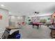 An expansive game room with a pool table, game machines, and bar seating at 2628 Cedar Shake Ct, Oviedo, FL 32765