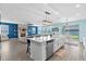 Open-concept kitchen featuring a large island, seating, and modern finishes at 2628 Cedar Shake Ct, Oviedo, FL 32765