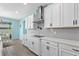 Bright kitchen featuring white cabinets, stainless steel vent hood, and subway tile backsplash at 2628 Cedar Shake Ct, Oviedo, FL 32765