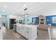 Open kitchen and living area featuring a large island, modern appliances, and comfortable seating at 2628 Cedar Shake Ct, Oviedo, FL 32765