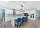 Eat-in kitchen with quartz counters, stainless appliances, subway tile backsplash, and island with bar seating at 2628 Cedar Shake Ct, Oviedo, FL 32765