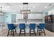Spacious kitchen island with seating, modern lighting, stainless steel appliances, and light countertops at 2628 Cedar Shake Ct, Oviedo, FL 32765