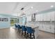 Modern kitchen with white cabinetry, stainless steel appliances, a center island, and stylish pendant lighting at 2628 Cedar Shake Ct, Oviedo, FL 32765