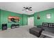 A beautifully decorated living room features a wall-mounted TV, a comfortable leather sectional, and a plush ottoman at 2628 Cedar Shake Ct, Oviedo, FL 32765