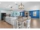 A modern, open-concept living space with a kitchen island and a cozy fireplace, perfect for entertaining guests at 2628 Cedar Shake Ct, Oviedo, FL 32765