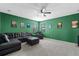 Comfortable carpeted living room with ceiling fan, leather sectional sofa, and fun movie posters for relaxing entertainment at 2628 Cedar Shake Ct, Oviedo, FL 32765