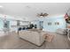 Open-concept living space with a modern kitchen, a large sectional sofa, and ample natural light at 2628 Cedar Shake Ct, Oviedo, FL 32765