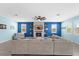 Cozy living room featuring a stone fireplace, built-in shelving, and a large, comfortable sectional sofa at 2628 Cedar Shake Ct, Oviedo, FL 32765