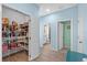 Walk-in pantry with ample shelving, leading to hall with bathroom and bedroom access at 2628 Cedar Shake Ct, Oviedo, FL 32765