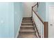 Carpeted stairway with white banister and wooden handrail, leading to the upper level at 2628 Cedar Shake Ct, Oviedo, FL 32765