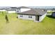 Expansive backyard with well-kept lawn and a sliding glass door, perfect for outdoor enjoyment at 264 Towns Cir, Haines City, FL 33844
