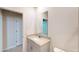 Light and airy bathroom with a sink with granite countertop and a large mirror at 264 Towns Cir, Haines City, FL 33844