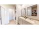 Stylish bathroom with double sinks, granite countertops, modern fixtures, and a glass shower enclosure at 264 Towns Cir, Haines City, FL 33844