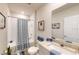 Well-lit bathroom with tiled shower/tub, stylish vanity, and beach-themed decor adding a touch of relaxation at 264 Towns Cir, Haines City, FL 33844