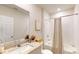 Well-lit bathroom with a granite vanity, shower with curtain, and neutral decor for a clean and inviting space at 264 Towns Cir, Haines City, FL 33844