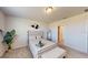 Bright bedroom with an upholstered headboard, a decorative mirror, and views of an ensuite at 264 Towns Cir, Haines City, FL 33844