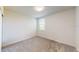 Minimalist bedroom with neutral carpet, a window offering natural light, and a simple, uncluttered design at 264 Towns Cir, Haines City, FL 33844