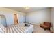 Sunlit bedroom featuring an upholstered headboard, and doorway views of the ensuite and closet at 264 Towns Cir, Haines City, FL 33844