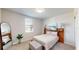 Cozy bedroom featuring a tufted ottoman, soft natural light, and comfortable neutral tones at 264 Towns Cir, Haines City, FL 33844