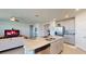 Open kitchen with a large island, stainless steel appliances, and a seamless flow to the living area at 264 Towns Cir, Haines City, FL 33844