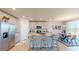 Well-lit kitchen with stainless steel appliances, center island, and adjacent dining area at 264 Towns Cir, Haines City, FL 33844