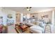 Bright, open living space with neutral tones, a ceiling fan, and a seamless flow to the kitchen and dining area at 264 Towns Cir, Haines City, FL 33844