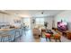 Open-concept living space with kitchen island, dining area, and comfortable seating arrangements at 264 Towns Cir, Haines City, FL 33844