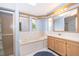 Bathroom featuring double sinks, garden tub, separate shower, and ample natural light at 2650 Einwood Dr, Kissimmee, FL 34758