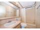 Bathroom features vanity with sink and a shower-tub combo, and floral wallpaper at 2650 Einwood Dr, Kissimmee, FL 34758