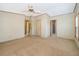 Spacious bedroom featuring neutral carpeting, ceiling fan, and multiple entryways at 2650 Einwood Dr, Kissimmee, FL 34758