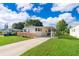 Well-kept home featuring a wheelchair ramp, covered carport, and lush landscaping at 2650 Einwood Dr, Kissimmee, FL 34758