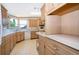 Well-lit kitchen with light wood cabinets, white countertops, and modern appliances at 2650 Einwood Dr, Kissimmee, FL 34758