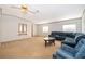 Inviting living room with carpeted floors and a comfortable blue sectional sofa at 2650 Einwood Dr, Kissimmee, FL 34758
