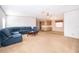 Cozy living room featuring carpeted floors, natural light, and a blue sectional sofa at 2650 Einwood Dr, Kissimmee, FL 34758