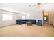 Spacious living room with carpeted floors and a comfortable blue sectional sofa and ceiling fan at 2650 Einwood Dr, Kissimmee, FL 34758