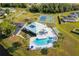 Overhead angle features the pool, tennis courts, and neighborhood recreation areas at 2650 Einwood Dr, Kissimmee, FL 34758
